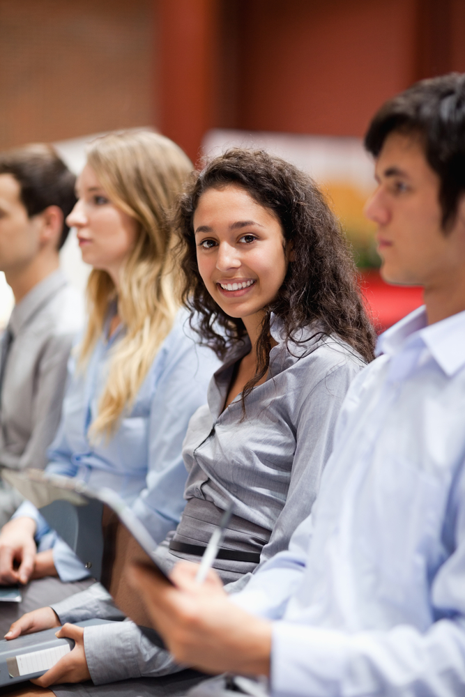 Portrait of a businesswoman smiling at the camera during a presentation Portrait of a businesswoman smiling at the camera during a presentation