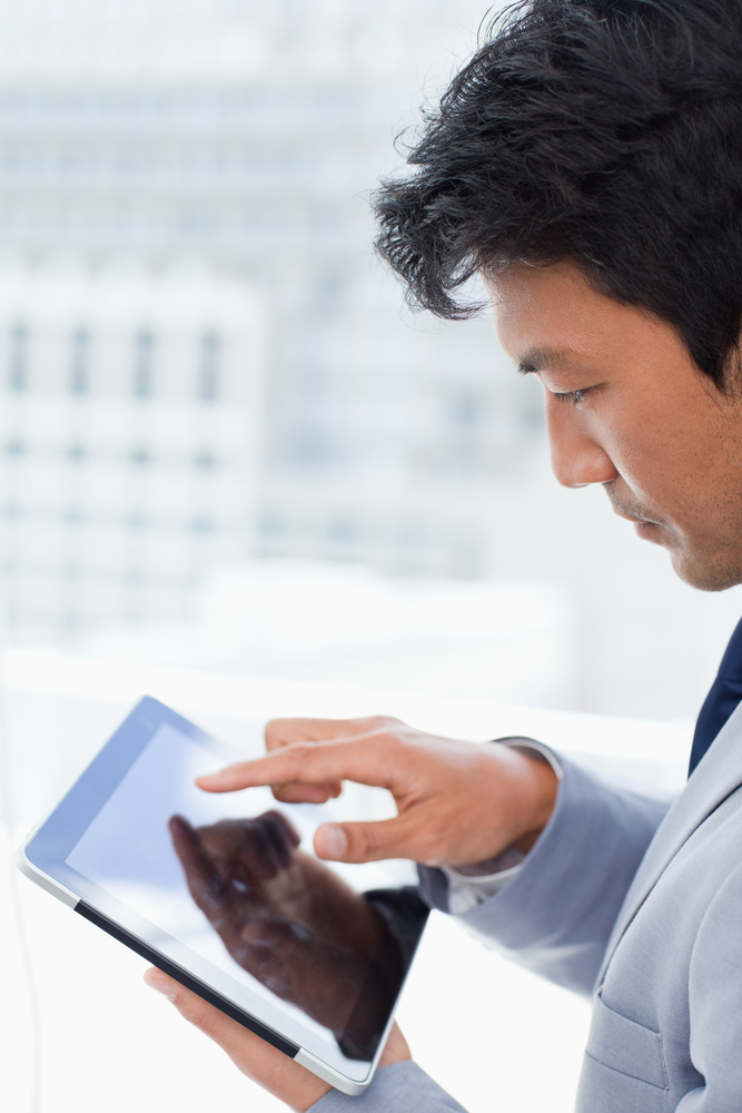 Portrait of a young office worker using a tablet computer in his office Portrait of a young office worker using a tablet computer in his office